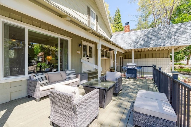 wooden deck with grilling area and an outdoor hangout area