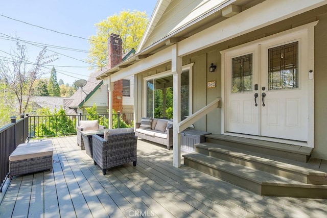 wooden deck featuring outdoor lounge area