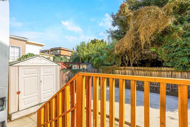 wooden terrace featuring a storage shed