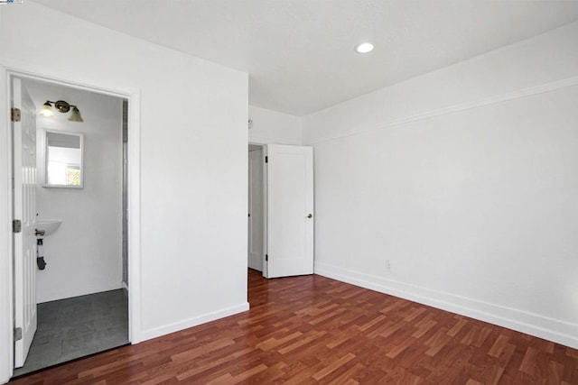 empty room with dark hardwood / wood-style flooring