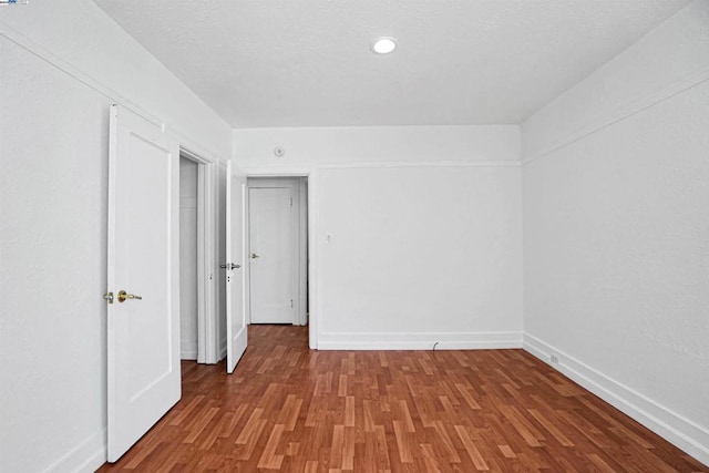 unfurnished room with hardwood / wood-style flooring