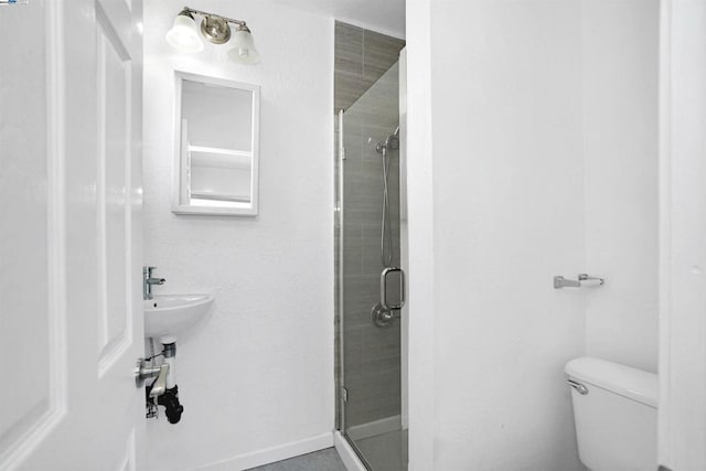 bathroom featuring toilet and an enclosed shower