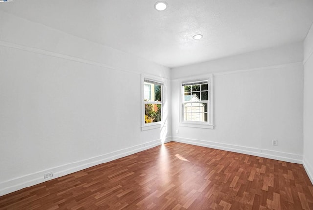 unfurnished room with dark hardwood / wood-style floors