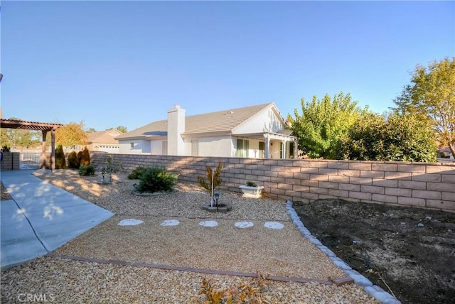 view of side of home featuring a pergola and a patio area