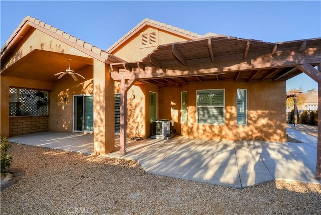 back of property with ceiling fan, cooling unit, a pergola, and a patio