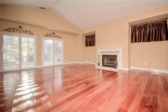 unfurnished living room with vaulted ceiling and hardwood / wood-style flooring