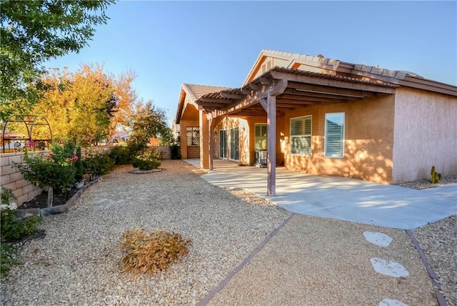 view of property exterior featuring a patio area