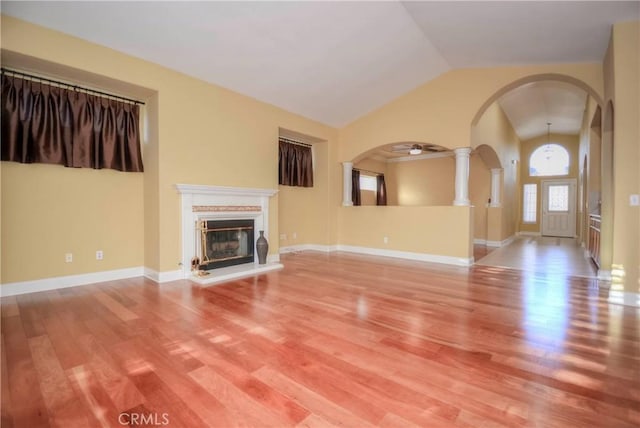 unfurnished living room featuring hardwood / wood-style floors and lofted ceiling