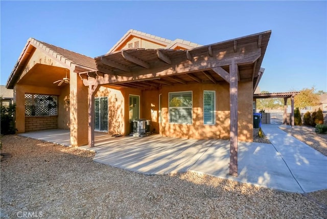 back of property with central AC, a pergola, a patio, and ceiling fan