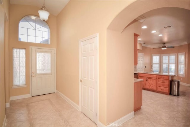 tiled entrance foyer with plenty of natural light and ceiling fan