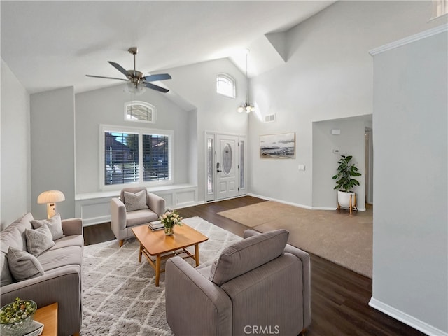 living room featuring dark wood-type flooring, a healthy amount of sunlight, and lofted ceiling