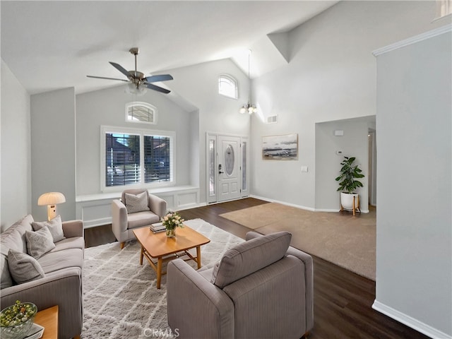 living room with dark wood-type flooring, ceiling fan, and high vaulted ceiling