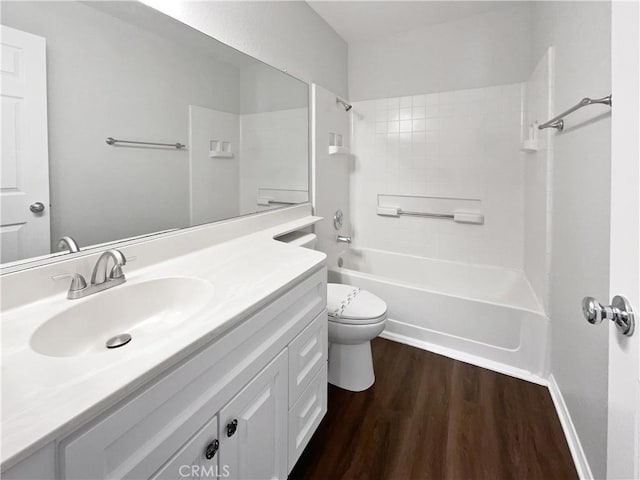 full bathroom featuring hardwood / wood-style floors, vanity, toilet, and tiled shower / bath combo