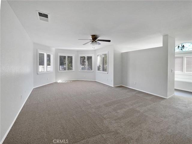 carpeted spare room with ceiling fan and a healthy amount of sunlight