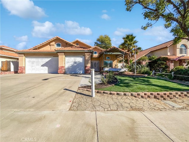 view of front of property featuring a garage and a front lawn