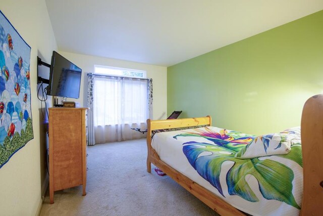 bedroom featuring light colored carpet