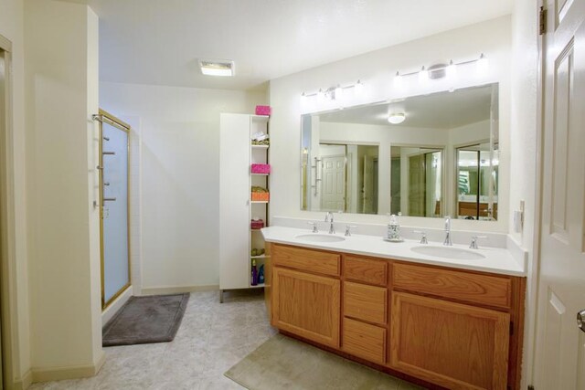 bathroom featuring vanity and an enclosed shower