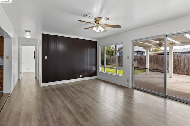 spare room featuring ceiling fan, crown molding, and hardwood / wood-style flooring