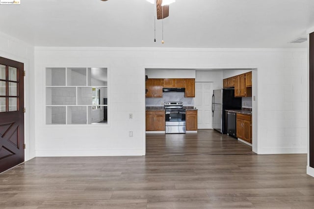 unfurnished living room featuring dark hardwood / wood-style flooring and ceiling fan