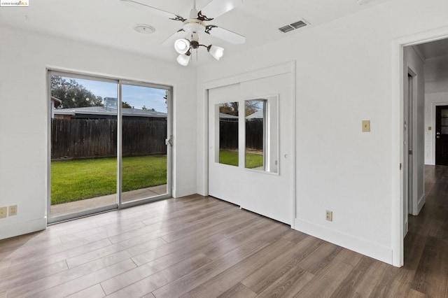 empty room with ceiling fan, crown molding, and light hardwood / wood-style flooring