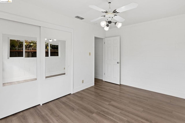 unfurnished room with hardwood / wood-style floors, ceiling fan, and ornamental molding