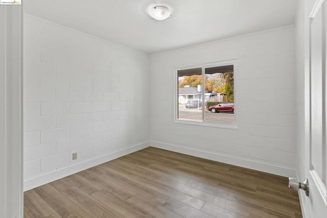 empty room with hardwood / wood-style flooring