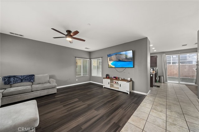 unfurnished living room with ceiling fan, a healthy amount of sunlight, and wood-type flooring