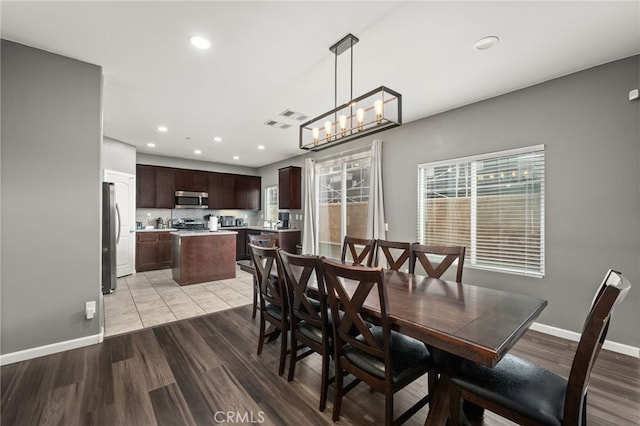 dining room featuring a chandelier and light hardwood / wood-style floors