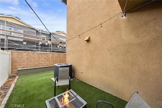 view of yard with a fire pit and cooling unit