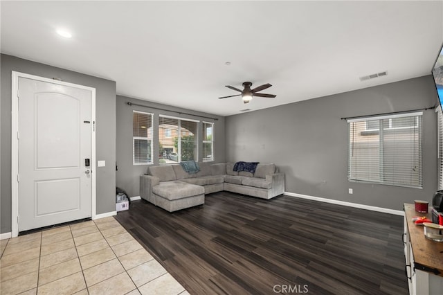 living room featuring ceiling fan and light hardwood / wood-style flooring