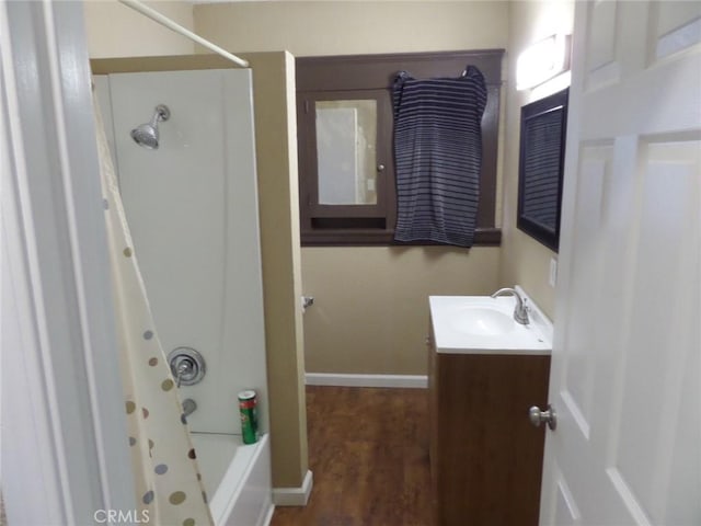 bathroom featuring hardwood / wood-style flooring, vanity, and shower / bath combo with shower curtain