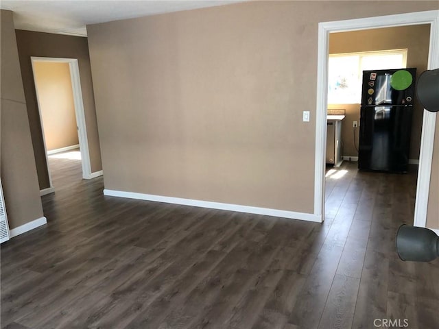 empty room featuring dark hardwood / wood-style flooring