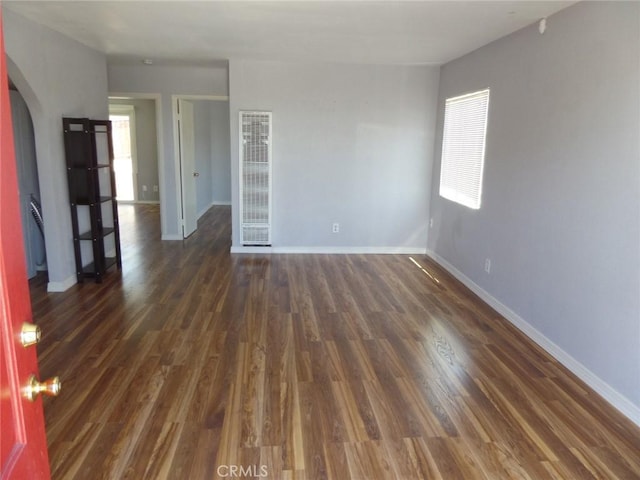 empty room with dark hardwood / wood-style floors