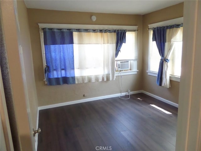 empty room with dark hardwood / wood-style flooring