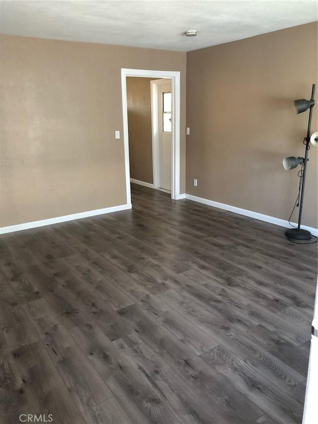 unfurnished room featuring dark hardwood / wood-style flooring