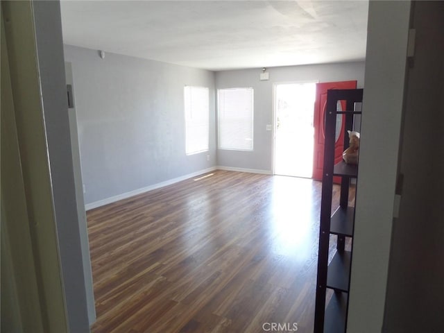 unfurnished room with dark wood-type flooring