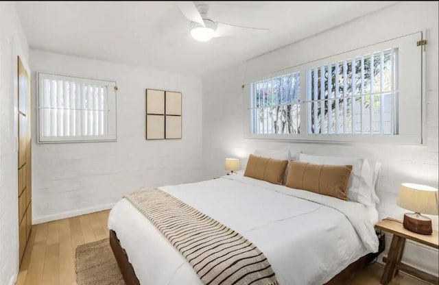 bedroom with ceiling fan and light wood-type flooring