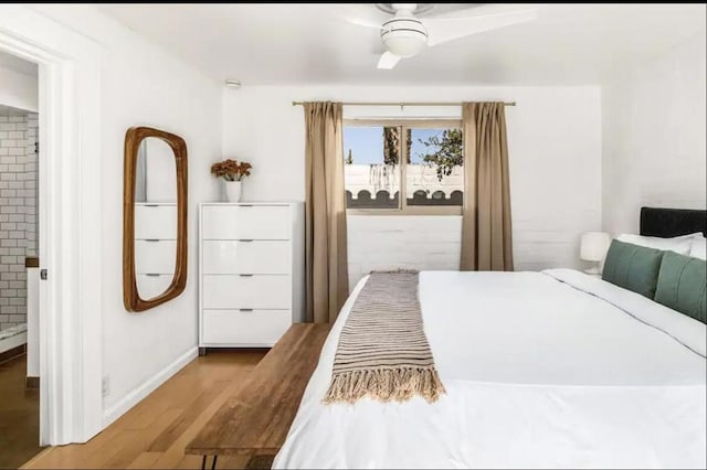 bedroom featuring ensuite bathroom, ceiling fan, and wood-type flooring