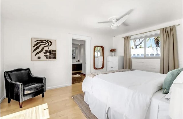 bedroom featuring ceiling fan, ensuite bathroom, and light hardwood / wood-style floors