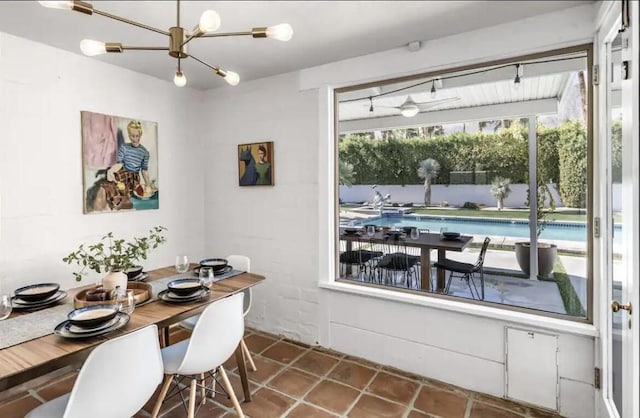 tiled dining area featuring a chandelier