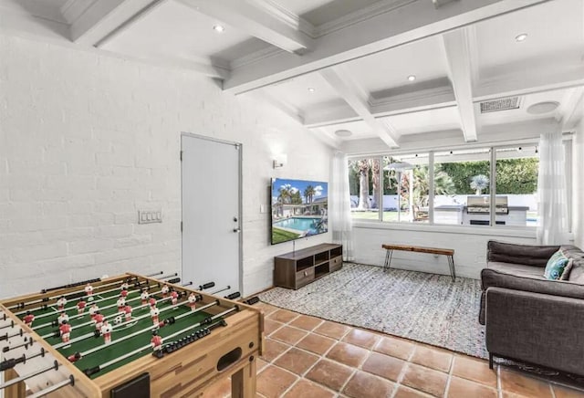 rec room with beam ceiling, tile patterned floors, brick wall, and ornamental molding