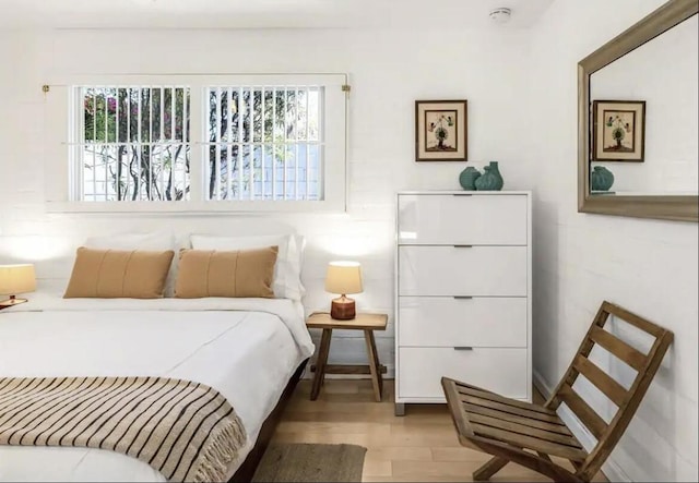 bedroom featuring multiple windows and light hardwood / wood-style floors