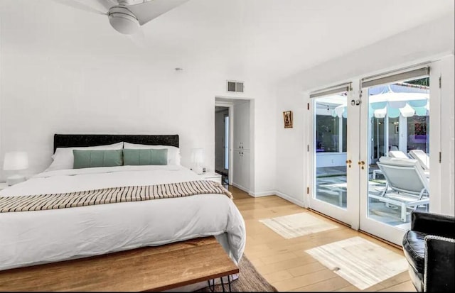 bedroom featuring ceiling fan, light hardwood / wood-style floors, access to outside, and french doors