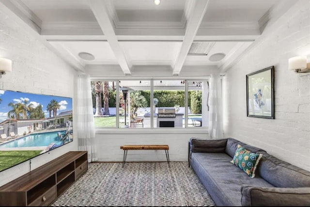 sunroom with beamed ceiling, a wealth of natural light, and coffered ceiling