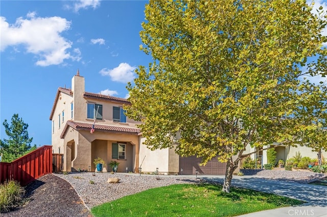 view of front of property featuring driveway, a tile roof, a chimney, fence, and stucco siding