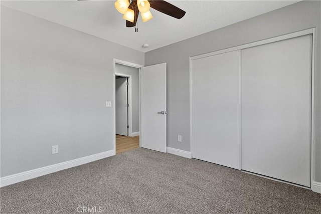 unfurnished bedroom featuring ceiling fan, light carpet, and a closet