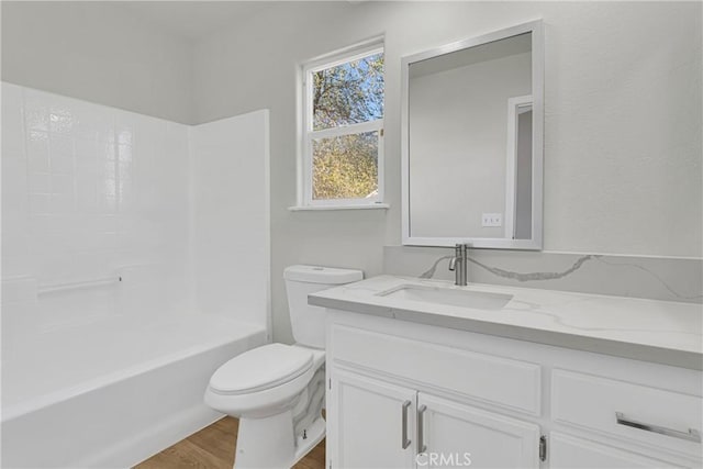 full bathroom with wood-type flooring, vanity, toilet, and shower / tub combination