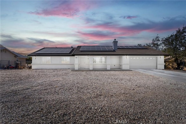 view of front of house with solar panels and a garage