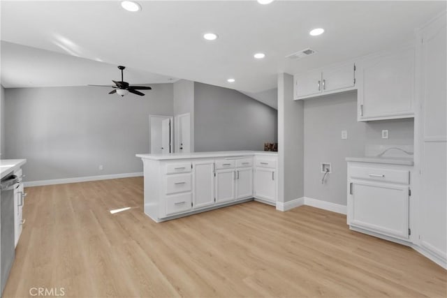 kitchen with white cabinetry, ceiling fan, light hardwood / wood-style flooring, kitchen peninsula, and vaulted ceiling