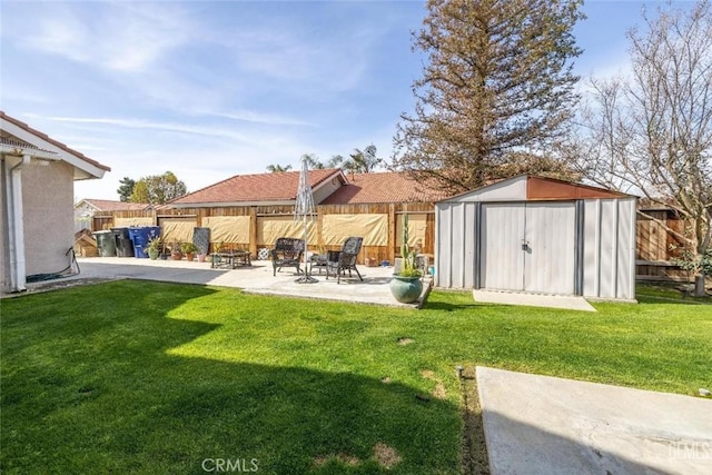 exterior space featuring a patio area, a yard, a fire pit, and a storage unit